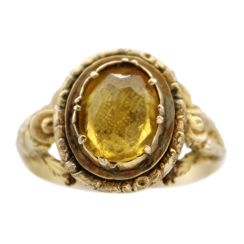 85 - A Georgian gold foiled paste ring and a gold citrine set ring. The Georgian ring with facetted oval ... 