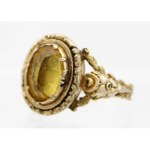 85 - A Georgian gold foiled paste ring and a gold citrine set ring. The Georgian ring with facetted oval ... 