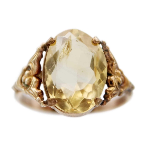 85 - A Georgian gold foiled paste ring and a gold citrine set ring. The Georgian ring with facetted oval ... 