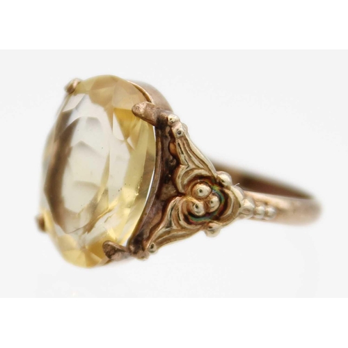 85 - A Georgian gold foiled paste ring and a gold citrine set ring. The Georgian ring with facetted oval ... 