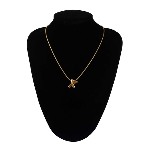 89 - An 18ct single diamond set pendant necklace by Werner Zappe Pforzheim.. The x shaped pendant set wit... 