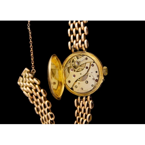 132 - An early 20th century 18ct cased manual wind lady's watch with 15ct bracelet. The watch with 18ct ba... 