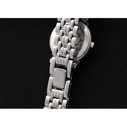 193 - TISSOT - A stainless steel lady's quartz bracelet wristwatch. Ref. T825/925, 23mm. Not currently run... 