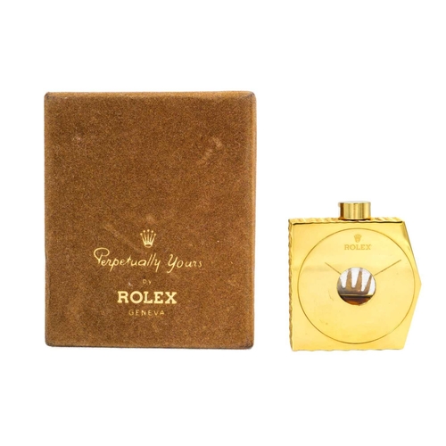 245 - A Rolex scent bottle, 'Perpetually Yours', Geneva. With contents, the angular gilt metal bottle with... 