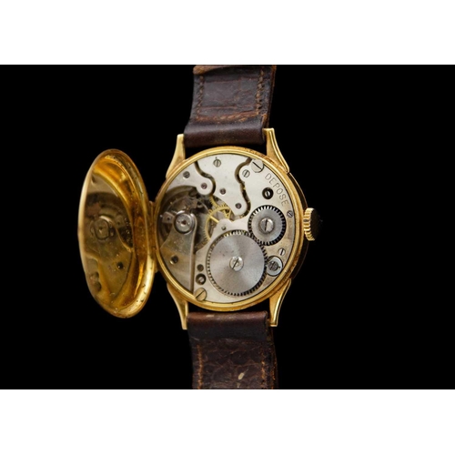 84 - An 18ct gold-cased 1920's manual wind gentleman's wristwatch. The 29mm dial with a silvered chapter ... 