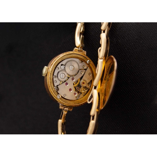 94 - A 1920's 9ct cased lady's manual wind wristwatch with 9ct expanding bracelet. The 20mm guilloche dia... 