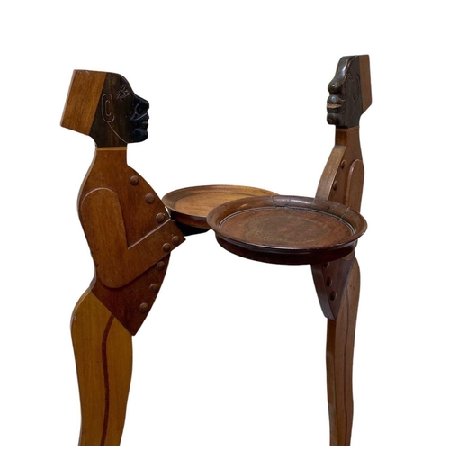 12 - A pair of mahogany figural dumb waiters. With lead weighted bases, height 98cm.