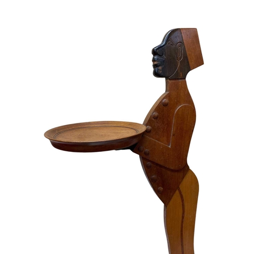 12 - A pair of mahogany figural dumb waiters. With lead weighted bases, height 98cm.