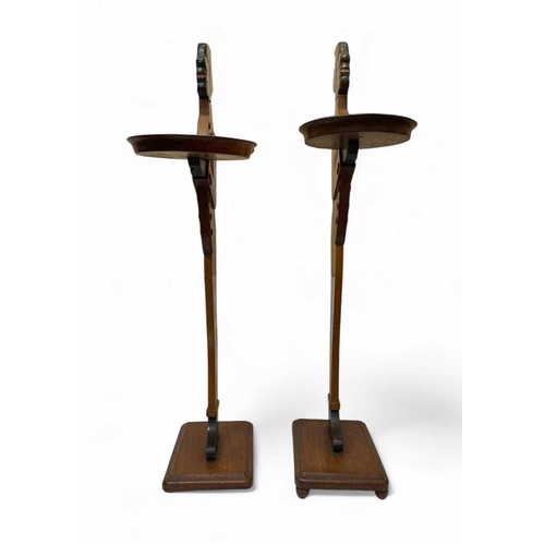 12 - A pair of mahogany figural dumb waiters. With lead weighted bases, height 98cm.