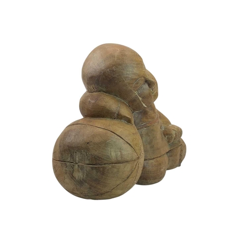 14 - A large wood carved sleeping Buddha with a ball. Height 30cm.