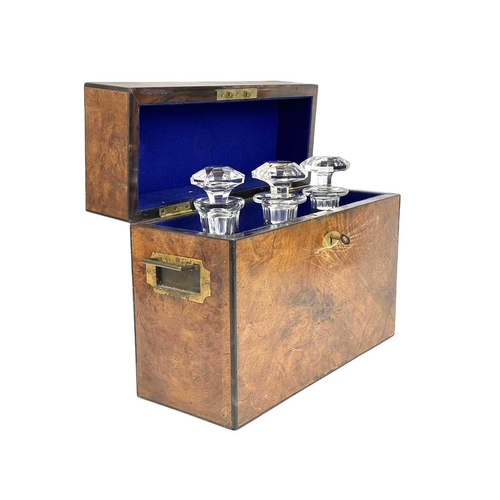 2 - A Victorian figured walnut campaign style tantalus. With folding brass side handles and fitted with ... 