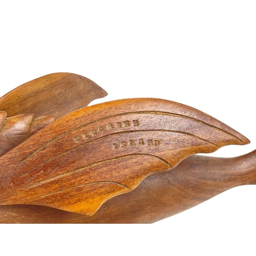 72 - A carved hardwood flying fish, stamped John Christian Pitcairn Island. Length 47cm, on a turned stan... 