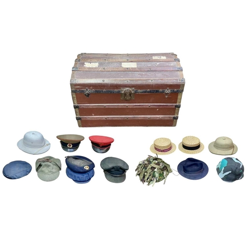 89 - A Trunk of various military and other headwear. Comprising two boaters, two pith helmets, a US balli... 