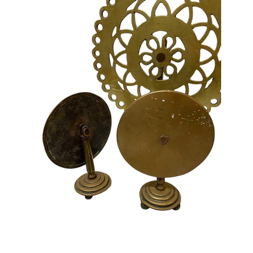 91 - A pair of Victorian brass candle reflectors. Height 18cm, together with a pair of marble mounted can... 