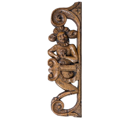 1002 - An Elizabethan oak grotesque carving of a satyr. Circa 1580, holding a flower and within a surround ... 