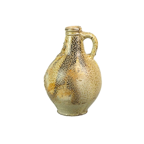 1019 - A German stoneware Bellarmine jug. 17th century, with a tiger glaze, impressed bearded mask, and lio... 