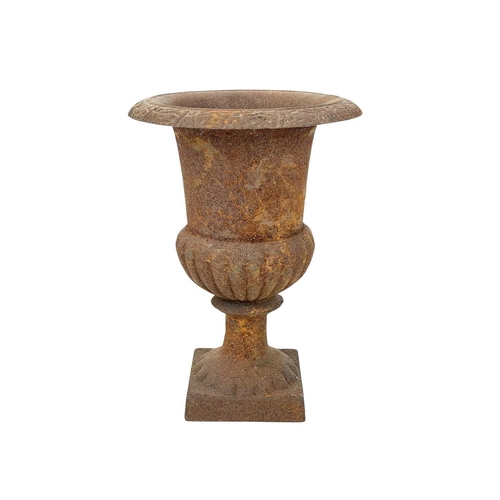 103 - A cast iron campana urn. On square base, height 24.5cm.