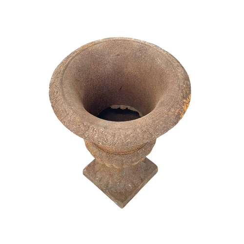 103 - A cast iron campana urn. On square base, height 24.5cm.