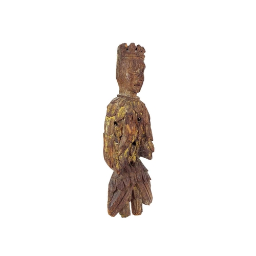 1031 - An English carved oak figure of a crowned angel. 15th century, with upheld hands, traces of gilt and... 