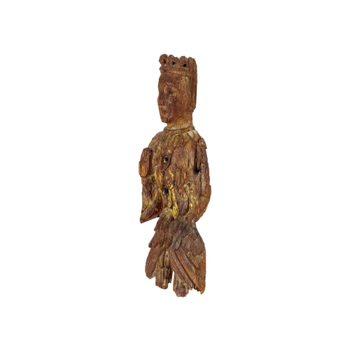 1031 - An English carved oak figure of a crowned angel. 15th century, with upheld hands, traces of gilt and... 