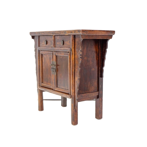 1035 - A Chinese elm side cabinet. Qing, 19th century, fitted two drawers above two doors within shaped sid... 