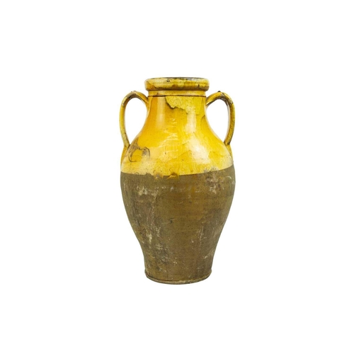 1037 - A French provincial yellow glazed large vase. 19th century, with twin handles and unglazed lower par... 