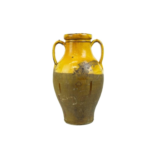 1037 - A French provincial yellow glazed large vase. 19th century, with twin handles and unglazed lower par... 