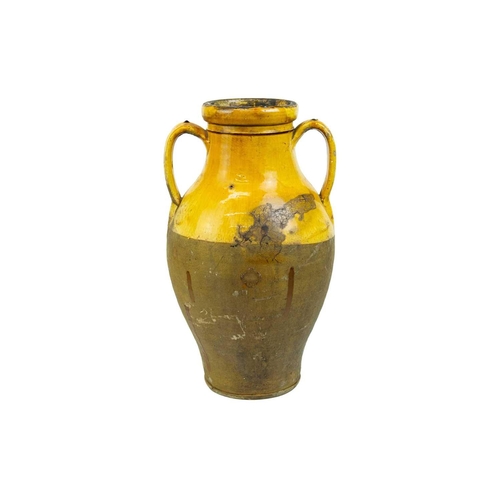 1037 - A French provincial yellow glazed large vase. 19th century, with twin handles and unglazed lower par... 