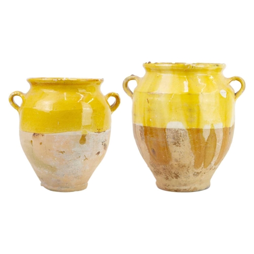 1040 - Two French provincial yellow glazed pots. 19th century, each with simple loop handles, height 16.5 a... 