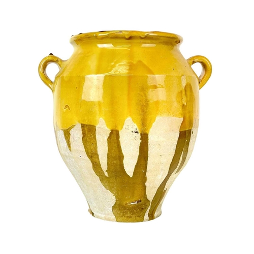 1042 - A French provincial yellow glazed pot. 19th century, with twin loop handles and unglazed lower part,... 