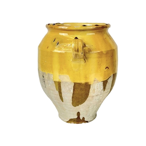 1042 - A French provincial yellow glazed pot. 19th century, with twin loop handles and unglazed lower part,... 