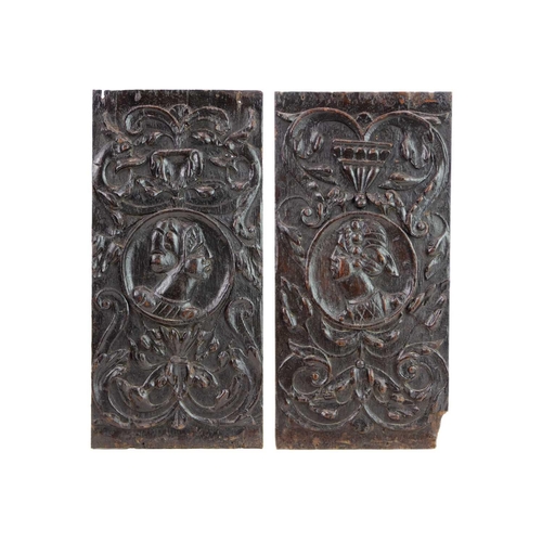 1046 - A pair of 16th century carved oak Romayne panels. Circa 1540, each with a portrait roundel within ca... 