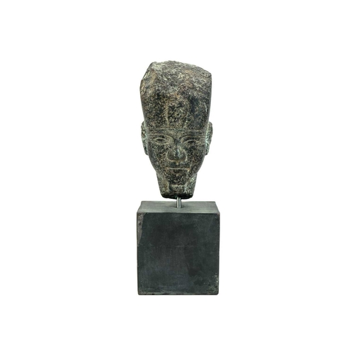 1051 - An Egyptian granite head of a pharaoh. Raised on a heavy base, the head height 15cm. Mollie & Graham... 