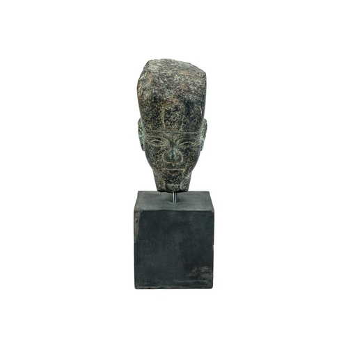 1051 - An Egyptian granite head of a pharaoh. Raised on a heavy base, the head height 15cm. Mollie & Graham... 