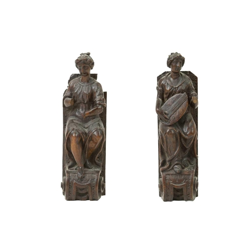 1057 - A pair of Italian walnut figures of musicians. 17th or early 18th century, one playing a lute, on vo... 