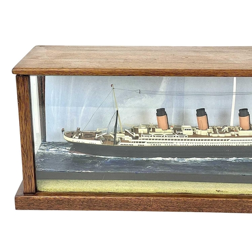 106 - A model of the Titanic. The glazed mahogany case incorporates an iceberg, overall length 65.5cm.