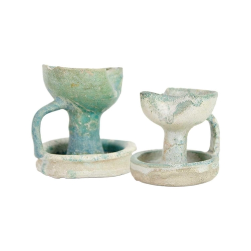 1069 - Two Islamic earthenware oil lamps. Probably Iran, 13th/14th century, the turquoise glaze with a silv... 