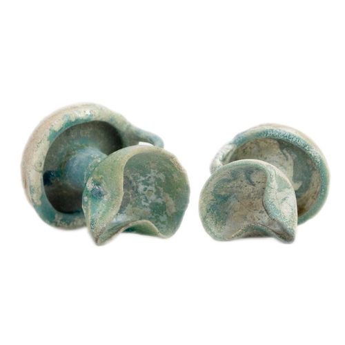 1069 - Two Islamic earthenware oil lamps. Probably Iran, 13th/14th century, the turquoise glaze with a silv... 