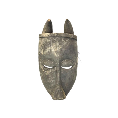 107 - An African probably Bambara antelope mask. Height 49cm.