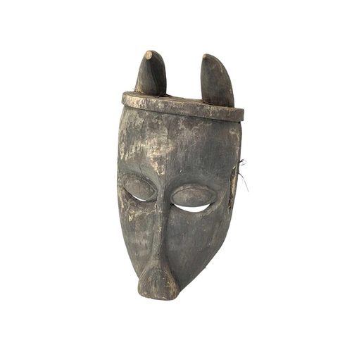 107 - An African probably Bambara antelope mask. Height 49cm.