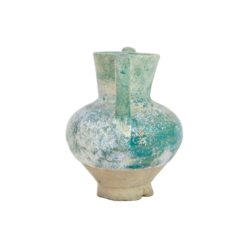 1072 - A Kashan turquoise glaze small spouted pot or ewer. 12th/13th century, with traces of silver lustre,... 