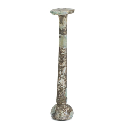 1073 - A Roman glass vial. With shallow domed base, tall stem, and flared rim, height 15cm. Mollie & Graham... 