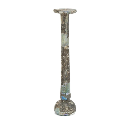 1073 - A Roman glass vial. With shallow domed base, tall stem, and flared rim, height 15cm. Mollie & Graham... 