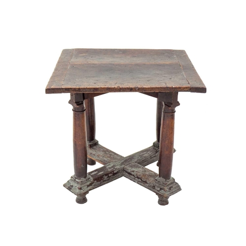 1074 - A Henri II walnut library or centre table. 16th century, the square top raised on stout turned legs,... 