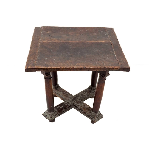 1074 - A Henri II walnut library or centre table. 16th century, the square top raised on stout turned legs,... 