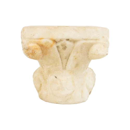 1076 - An alabaster carved column capital. With foliate scrolls and lotus decoration, height 11.5cm. Mollie... 