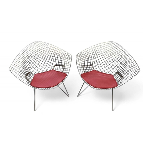 1092 - After Harry Bertoia a pair of 'Diamond' armchairs. Modern, of wire mesh construction, with red padde... 