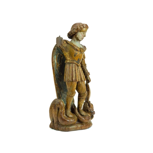 1103 - A carved oak figure of St Michael vanquishing Satan. Probably French, 15th century, with traces of t... 