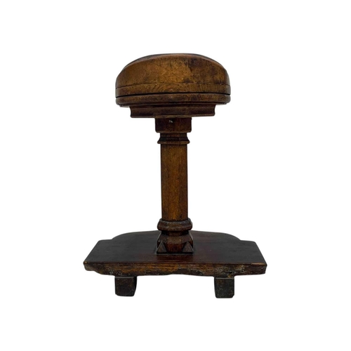 1110 - A Flemish oak Cleric's stool. 17th century, with a circular top with a slightly raised back, on an o... 