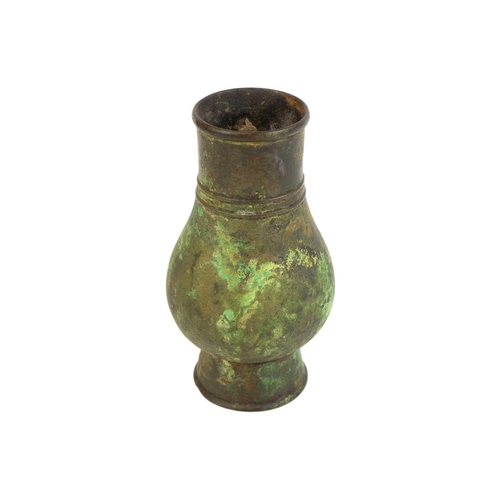 1117 - A Chinese bronze Hu vase. Han dynasty, of pear shape, with a girdled neck, height 14cm. Mollie belie... 